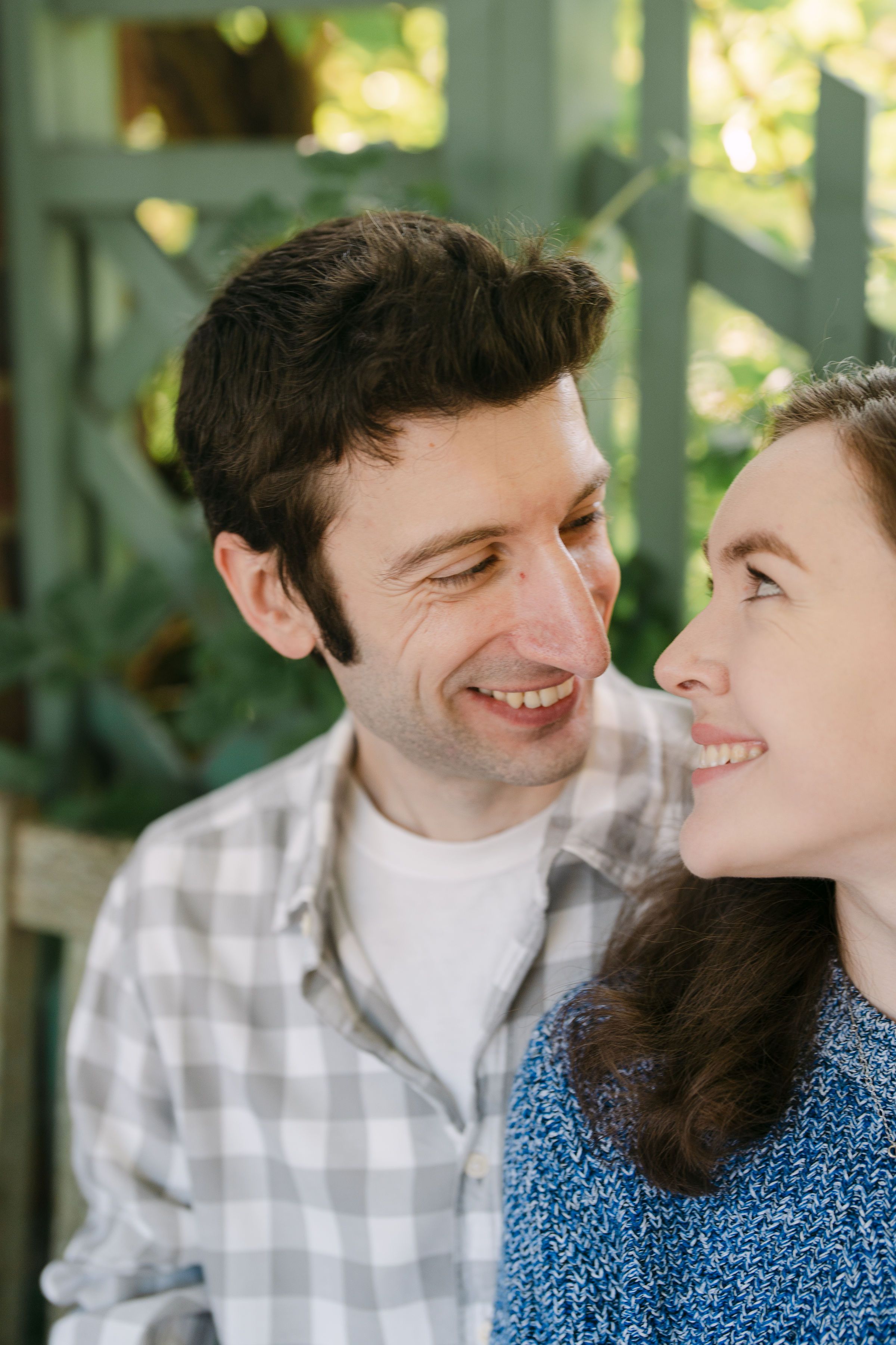Ellen and Andrew sitting down gazing at each other (Engagement shoot)